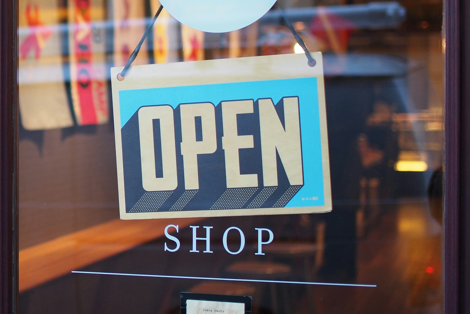 Open sign hanging in a shop door (stock photo)