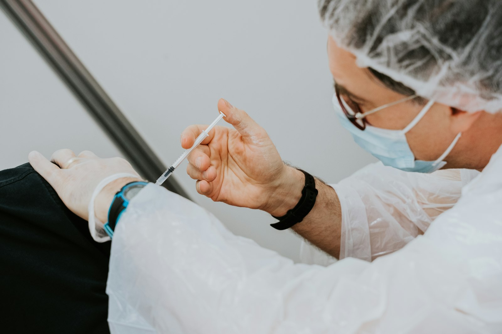 Pharmacist administering a vaccine (stock photo)